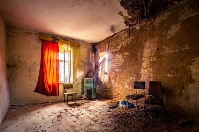 Ein Zimmer mit Stuhl und Fenster