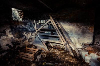 Ein Zimmer mit einer kaputten Toilette und einem Haufen Holz