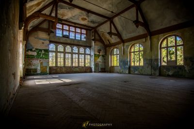 Ein großer Raum mit vielen Fenstern und viel Holz