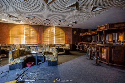 Ein Zimmer mit einer Couch, Stühlen und einer Bar