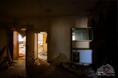 Ein Zimmer mit einer kaputten Tür und einem Fenster