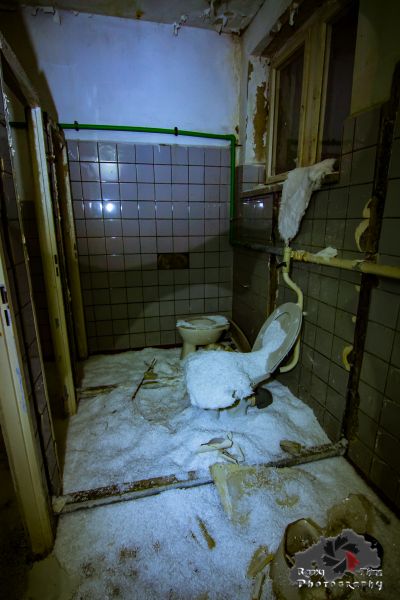 Ein schmutziges Badezimmer mit einer Toilette und einem Haufen Toilettenpapier