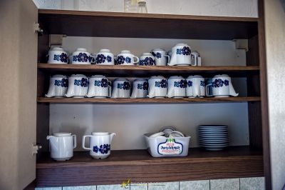 Ein Regal mit einem Haufen Tassen und Schalen darauf