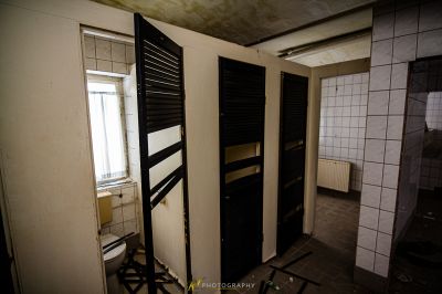 Ein Badezimmer mit einer schwarzen Tür und einem Fenster