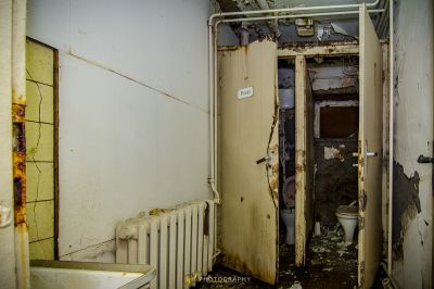 Ein schmutziges Badezimmer mit einer Toilette und einem Rad