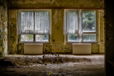 Ein Zimmer mit einem kaputten Fenster und einem kaputten Rad