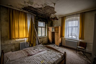 Ein Bett in einem Zimmer mit einer gebrochenen Decke