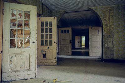 Ein Zimmer mit einer Tür und einer tapezierten Wand