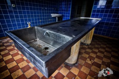 Ein Waschbecken in einem Badezimmer mit blau gefliester Wand