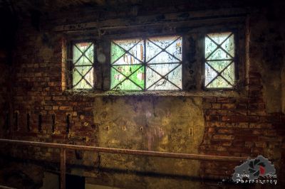 Ein Zimmer mit einem Fenster und einer Ziegelwand