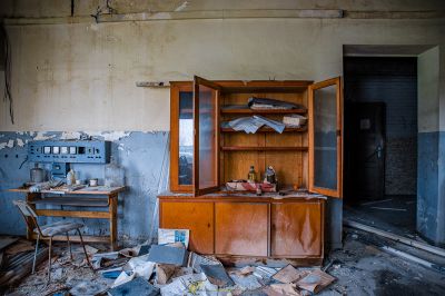 Ein Zimmer mit einem Schreibtisch und einem Schrank