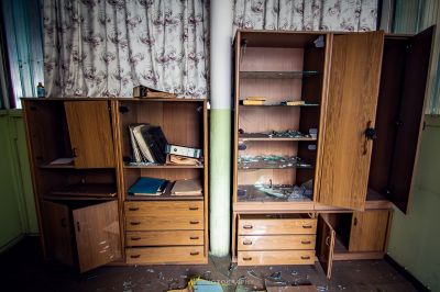 Ein Zimmer mit einem Schreibtisch und einem Schrank