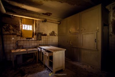 Eine schmutzige Küche mit Waschbecken und Fenster