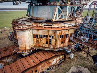 Ein verrosteter Zugwagen sitzt in einem Feld