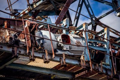 Ein verrostetes Auto sitzt auf einer Metallstruktur
