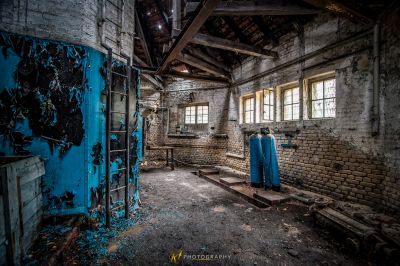 Ein Zimmer mit einer blauen Tür und einer Ziegelwand