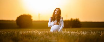 Eine Frau in einem weißen Kleid, das auf einem Feld steht