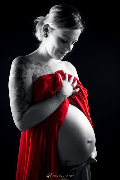 Eine schwangere Frau in einem roten Kleid