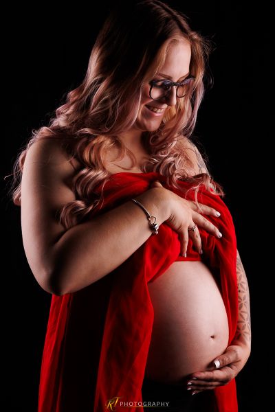 Eine schwangere Frau in einem roten Kleid